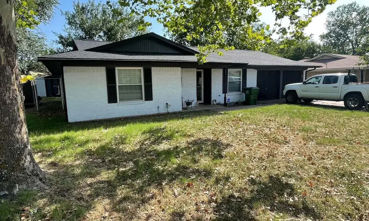 Professional roofing crew working on a residential roof in Florence